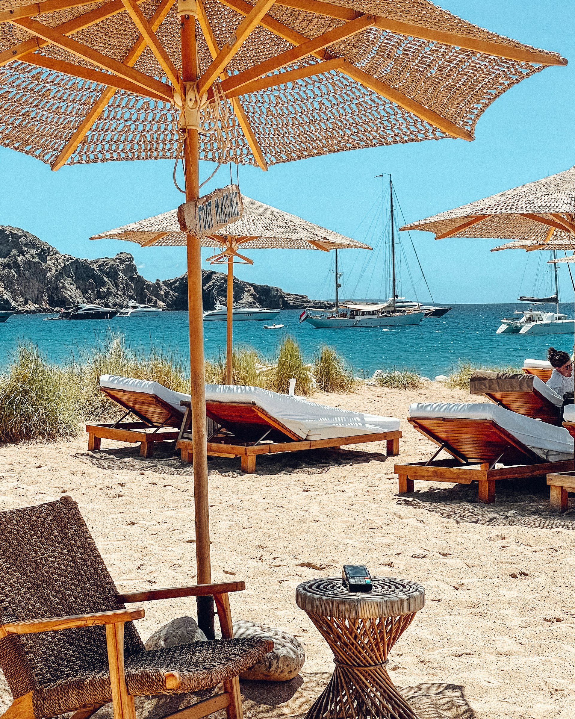 Beach club loungers and parasols at Cala Jondal
