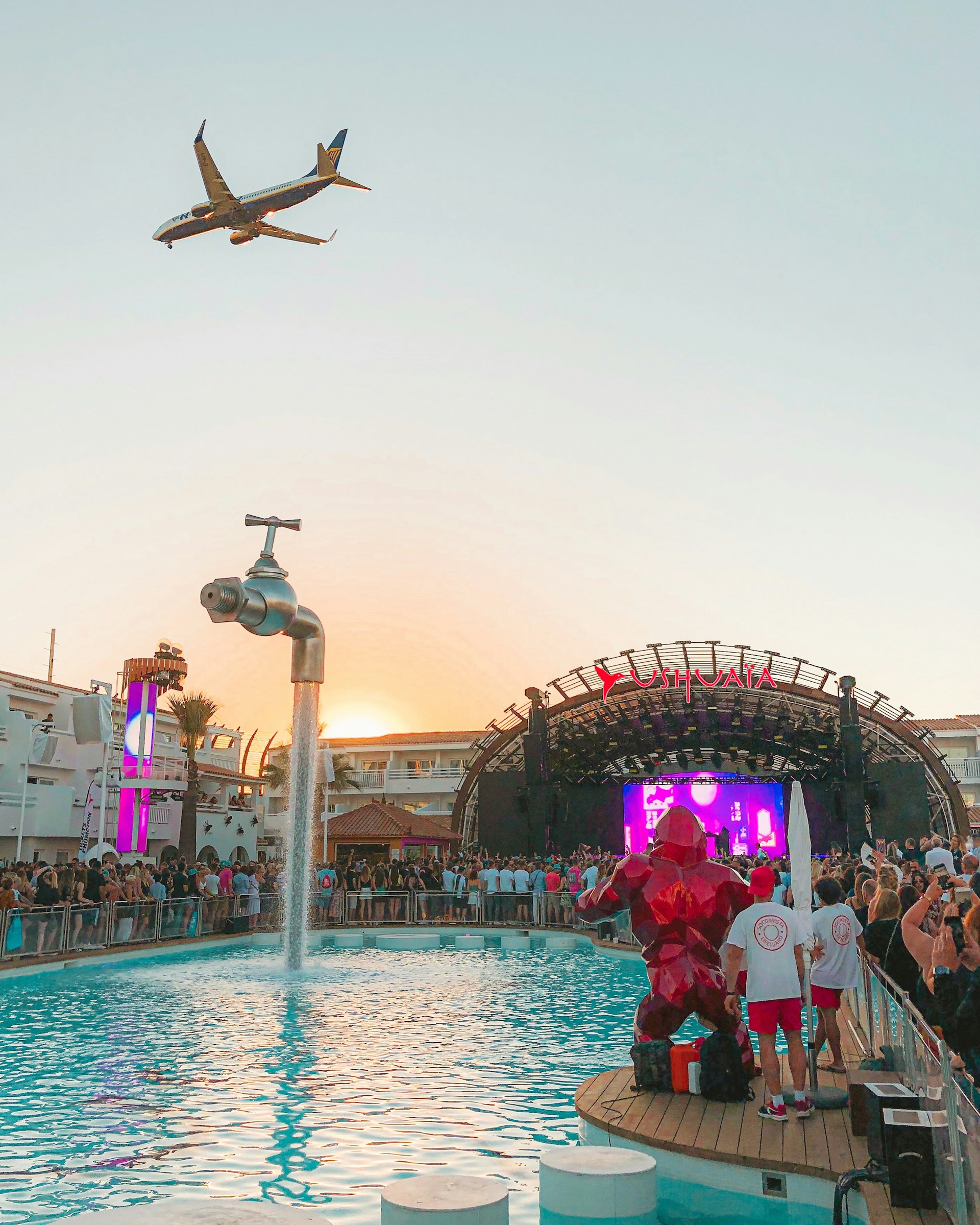 Pool party with a DJ stage and a plane flying overhead, Playa d'en Bossa, Ibiza